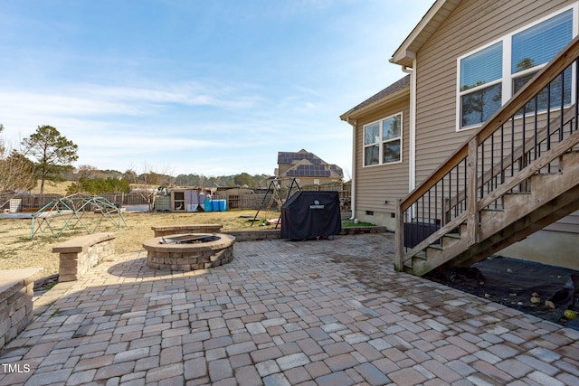 view of patio / terrace with fence and a fire pit