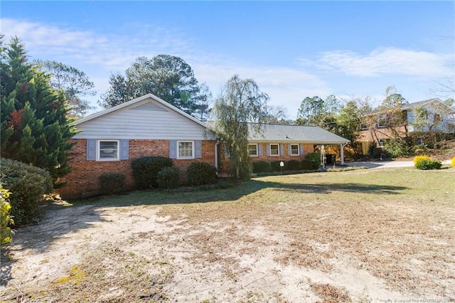 ranch-style house with brick siding and a front lawn