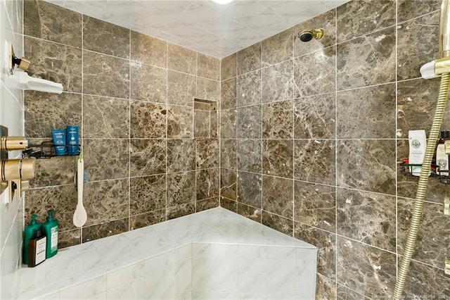 bathroom with tiled shower