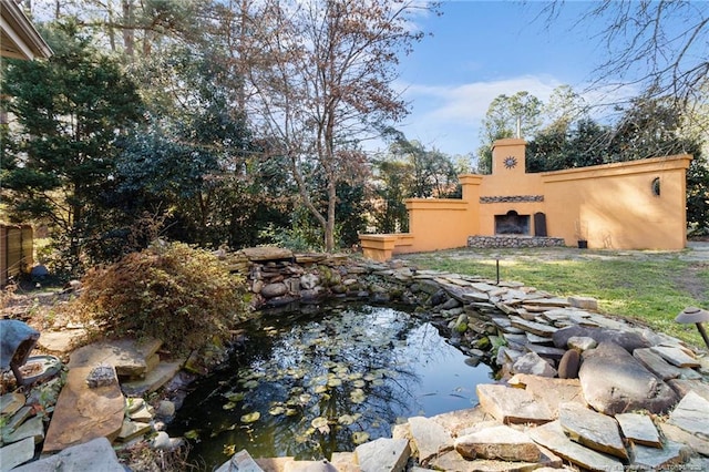 view of yard featuring a small pond