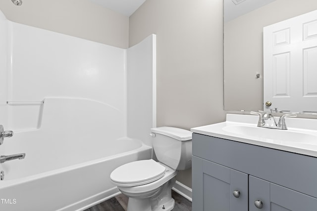 full bathroom featuring toilet, shower / bath combination, wood finished floors, and vanity