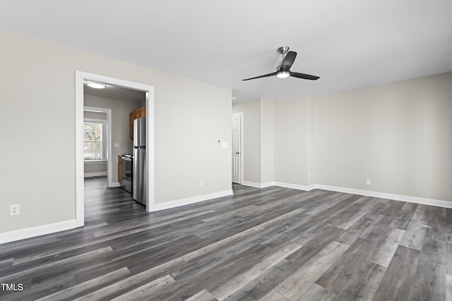 empty room with dark wood-style floors, baseboards, and a ceiling fan