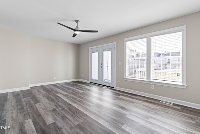 interior space with visible vents, baseboards, dark wood finished floors, a ceiling fan, and french doors