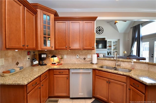 kitchen featuring ornamental molding, dishwasher, decorative backsplash, and a sink