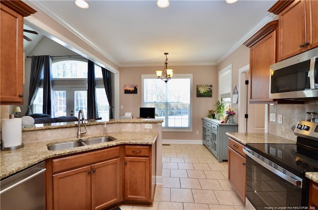 kitchen with brown cabinets, crown molding, stainless steel appliances, backsplash, and a sink