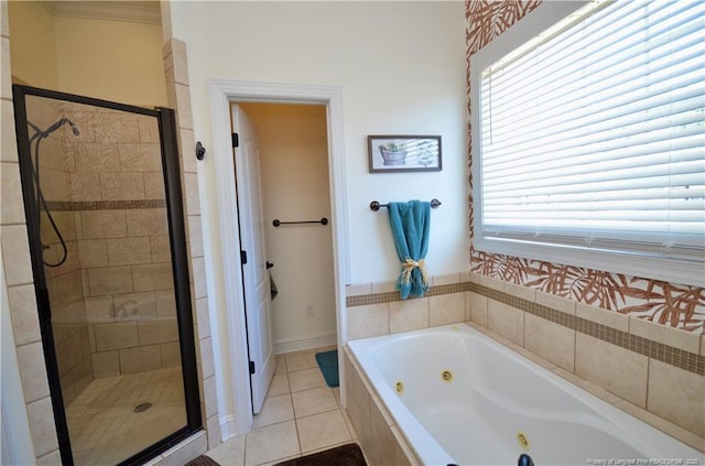 full bath featuring a shower stall, a tub with jets, and tile patterned floors