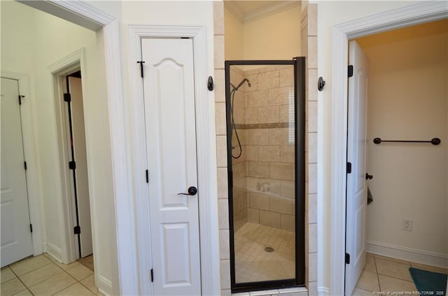 bathroom featuring a shower stall, baseboards, and tile patterned floors