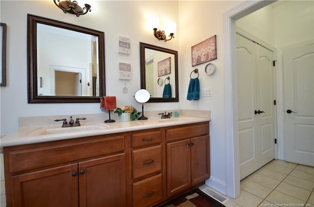 full bath with double vanity, tile patterned flooring, a sink, and visible vents