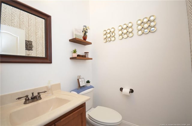 bathroom featuring vanity and toilet