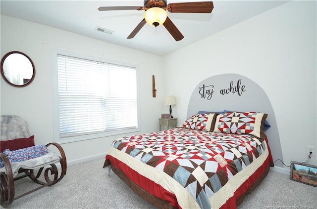 carpeted bedroom with baseboards, visible vents, and ceiling fan