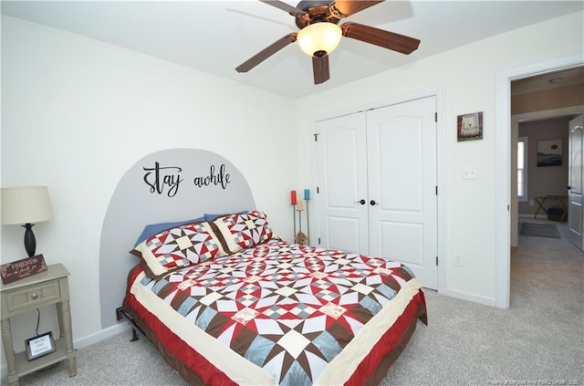 bedroom with carpet, a closet, ceiling fan, and baseboards