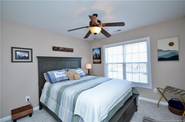 carpeted bedroom featuring visible vents, ceiling fan, and baseboards