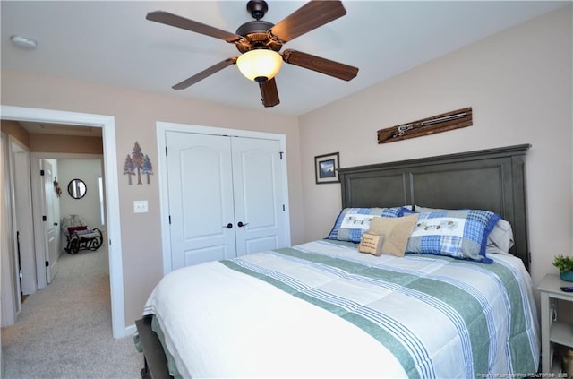 bedroom with ceiling fan, baseboards, a closet, and light colored carpet