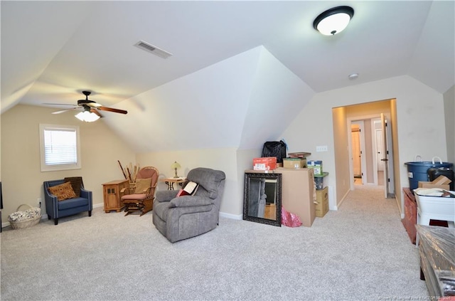 living area featuring lofted ceiling, carpet floors, baseboards, and visible vents