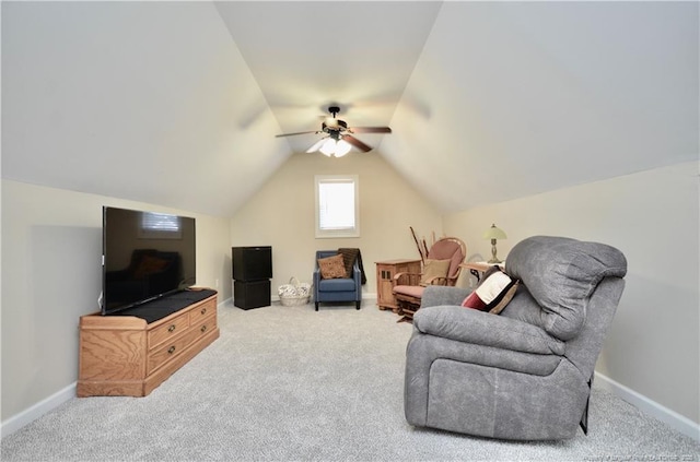 living area featuring lofted ceiling, baseboards, and carpet flooring