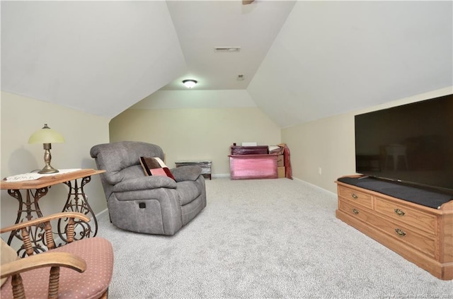 living area featuring vaulted ceiling, carpet, visible vents, and baseboards