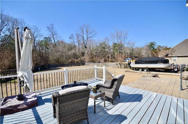 wooden deck with a fenced backyard