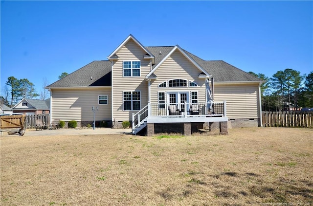 back of house featuring crawl space, fence, and a yard