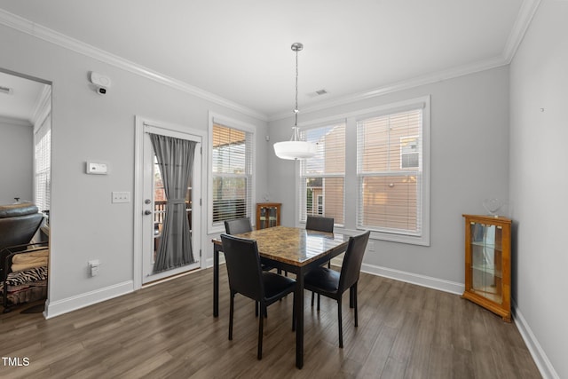 dining area featuring crown molding, visible vents, dark wood finished floors, and baseboards