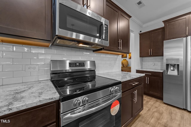 kitchen with stainless steel appliances, light wood-type flooring, crown molding, and dark brown cabinetry