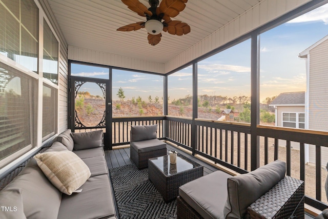 sunroom featuring ceiling fan and plenty of natural light