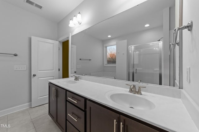 full bath with a stall shower, visible vents, a sink, and tile patterned floors