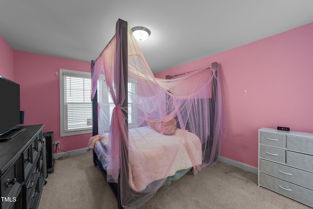 bedroom with light carpet and baseboards