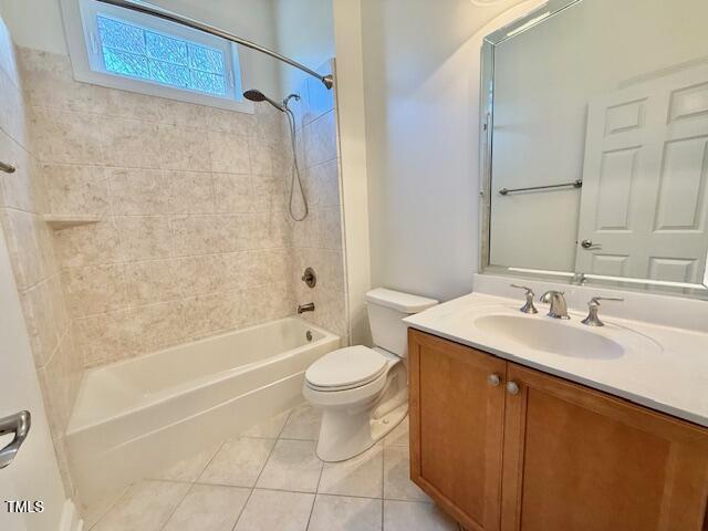 bathroom with tile patterned flooring, toilet, vanity, and bathtub / shower combination