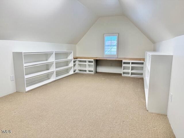 additional living space featuring vaulted ceiling and carpet flooring