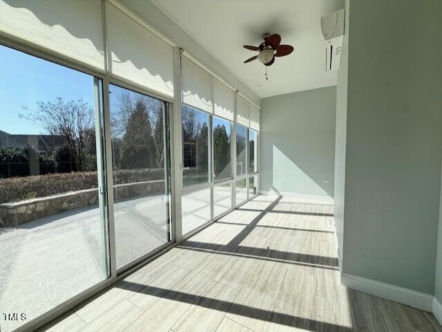 unfurnished sunroom with a wealth of natural light and ceiling fan