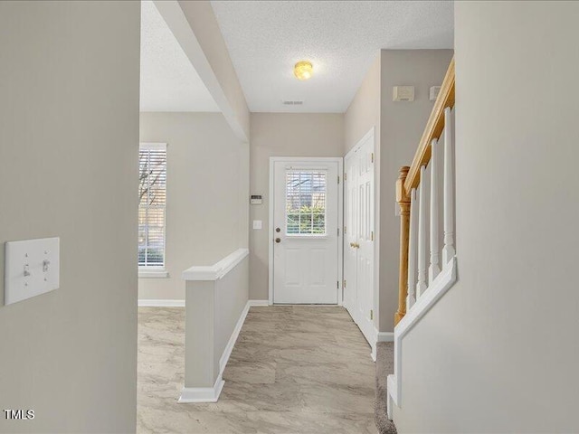 706 Canyon Lake Cir, Morrisville, NC 27560 - foyer entrance featuring stairway, baseboards, a textured ceiling, and marble finish floor