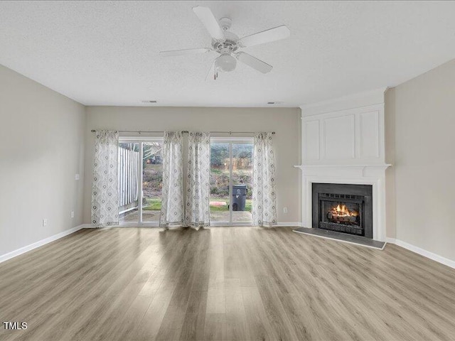 706 Canyon Lake Cir, Morrisville, NC 27560 - unfurnished living room with a fireplace, baseboards, ceiling fan, and light wood-type flooring