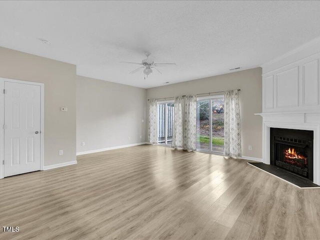 706 Canyon Lake Cir, Morrisville, NC 27560 - unfurnished living room with baseboards, ceiling fan, a fireplace, and light wood finished floors