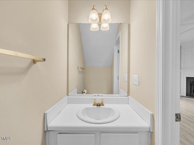 706 Canyon Lake Cir, Morrisville, NC 27560 - bathroom with a fireplace, a notable chandelier, and vanity