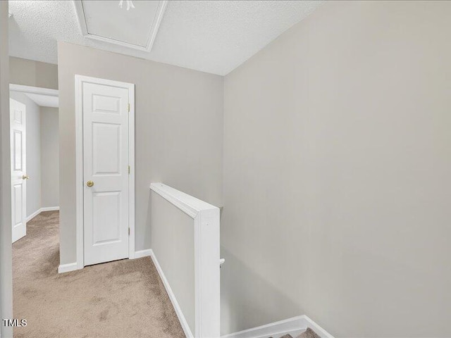 706 Canyon Lake Cir, Morrisville, NC 27560 - hall featuring light colored carpet, a textured ceiling, baseboards, and an upstairs landing
