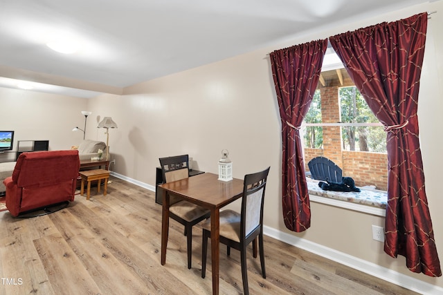 dining room featuring baseboards and wood finished floors