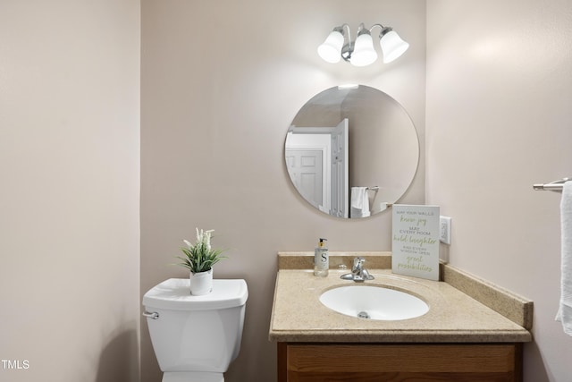 bathroom featuring toilet and vanity