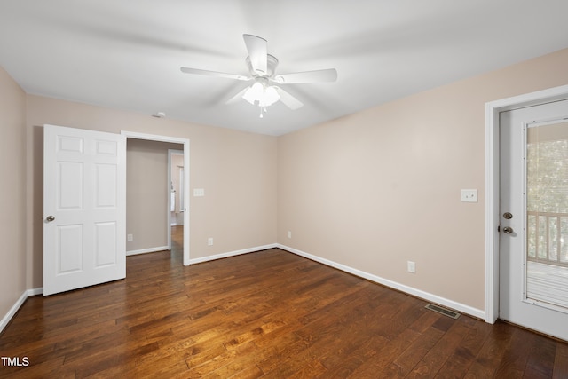 unfurnished bedroom featuring wood-type flooring, visible vents, baseboards, and multiple windows