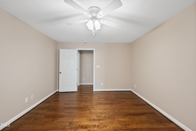 spare room with ceiling fan, baseboards, and wood finished floors