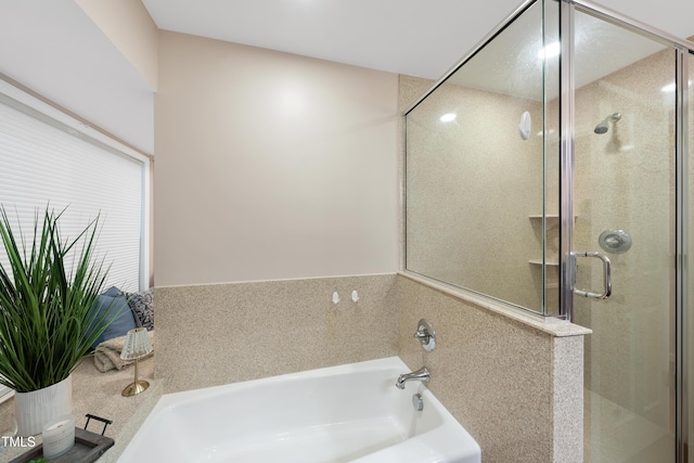 bathroom featuring a garden tub and a shower stall