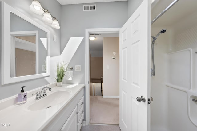 bathroom featuring a shower, visible vents, and vanity