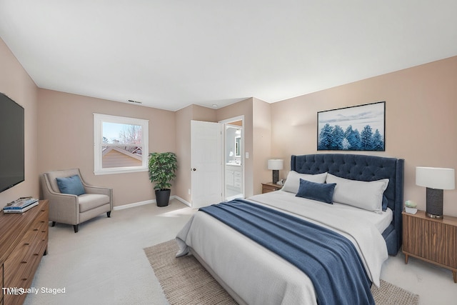 bedroom with baseboards, visible vents, and light colored carpet