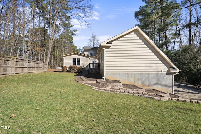 view of property exterior with a yard and fence