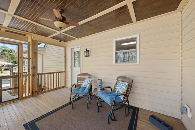 sunroom / solarium featuring a ceiling fan and wooden ceiling