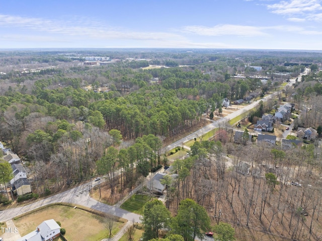 drone / aerial view featuring a forest view