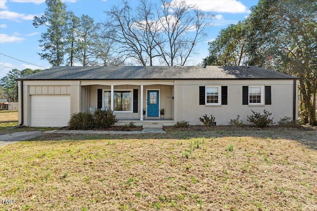 single story home with a garage, aphalt driveway, a front lawn, and brick siding