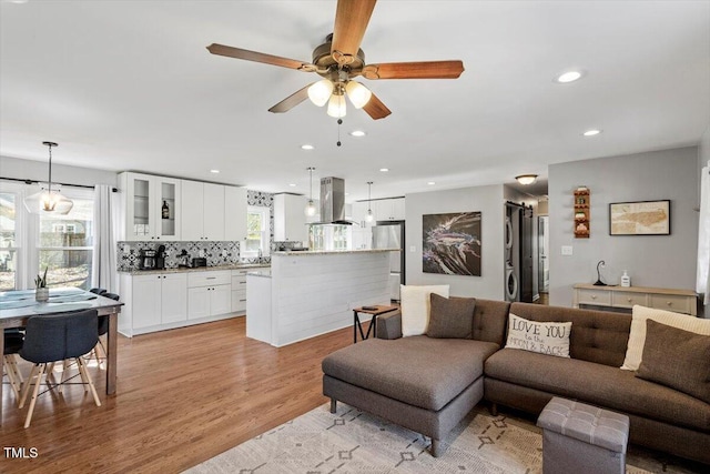 living area with ceiling fan, light wood finished floors, and recessed lighting