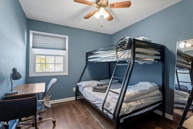 bedroom featuring wood finished floors, a ceiling fan, and baseboards