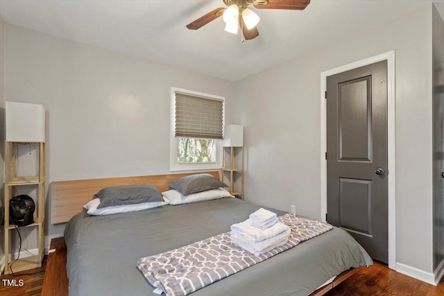 bedroom with baseboards, a ceiling fan, and wood finished floors