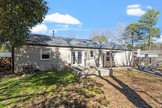 back of property with a patio, central AC unit, brick siding, fence, and french doors